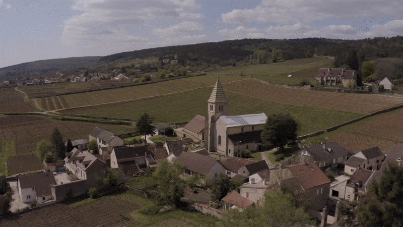 Flying over the church in a vineyard in Fixin